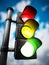 Traffic lamp with red, yellow and green lights on against blue background. 3D illustration
