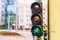 A traffic light for a bicycle. At the traffic light for a bicyclist, a green light is on.