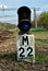 Traffic light on a railway with a sign of `22 meters`