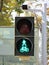 Traffic light showing a bright blue person on a bicycle