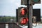 Traffic light with a timer for pedestrians on an old rusty post in the city.