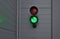 Traffic light with two lights. placed on a metal gray facade of a garage or warehouse. used to enter trucks to the loading ramp fo