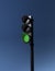 traffic light with working green signal isolated on blue sky background