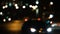 Traffic lights on the city roads. Blurred defocused light on traffic in the deep dark night.