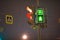 Traffic lights, pedestrian green light and sign at night