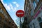 Traffic prohibition road sign on the on the background of the old street and  blue sky with clouds