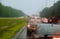 Traffic in rainy day with road car window with rain drops