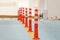 Traffic restrictive plastic poles, orange with white stripes, selective focus