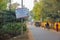 Traffic on a road lined with trees in the rural outskirts of the town of Bolpur