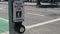 Traffic rolls by a street crossing push button, Mission Street, San Francisco