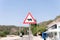 Traffic safety signs on city street road. triangular danger sign of the movement of animals livestock cows. danger warning symbol