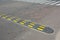 Traffic safety speed bump with crosswalk on an asphalt road. Speed bumps (or speed breakers)