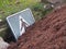 Traffic sign buried in pile of earth