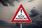 Traffic sign with covid-19 corona virus and the german translation for travel warning - Reisewarnung with dark cloudy sky