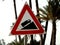 A traffic sign danger steep hill road ahead, a truck on an uphill signal, caution for vehicle drivers to beware of a steep hill in