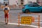 Traffic sign directing pedestrians to change sidewalks in french in front of a pedestrian crossing