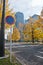Traffic sign of No Parking and Golden leaves foliage ginkgo Maidenhair trees in front of high-rise corporate office buildings