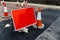 Traffic sign with red background next to several cones