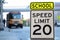 Traffic sign.  School zone  yellow warning board. Speed limit 20