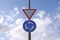 Traffic signs on blue sky background. Circular motion road sign and give way sign