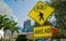 Traffic signs on city road in miami, usa. Bicycle and pedestrian crossing ahead warning. Transportation traffic and