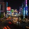 Traffic streams into the Shinjuku district at night in Tokyo, Japan.