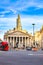 Traffic at a street corner in the bank district of London with historic and modern buildings