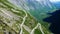 Traffic on Trollstigen or Trolls Path, a popular serpentine mountain road with 11 hairpin turns and Isterdalen valley near