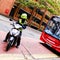 Traffic Warden Sitting On A Motor Scooted In Front Of A Bus