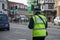 Traffic warden walks down a busy high street in the UK