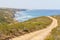 Trail, beach, mountains and vegetation in Arrifana