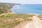 Trail, Cliffs, beach, mountains and vegetation in Canal beach