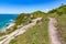 Trail with cliffs vegetation,  waves and rocks