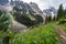 Trail en route to the Plain of Six Glaciers in Banff National Park, in the Lake Louise area. Defocused wildflowers in foreground