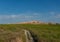 Trail Through Field Below Badlands