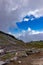 trail through harsh mountain landscape with clouds