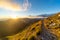 Trail on the mountain peak with golden light at dawn on the Apuan Alps Alpi Apuane, Tuscany, Lucca