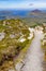 Trail over Diamond hill with Ballynakill Bay and mountains in ba