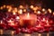 A trail of red rose petals leading to a group of lit candles. The candles are set against a dim, soft-focus background, creating a