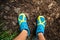 Trail runner looking down at sports shoe, running in nature