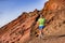 Trail runner man athlete ultra running in mountain rocky path in nature. Volcano mountains backcountry landscape. Fitness and