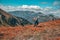 Trail runner on mountains meadow. Beautiful hills in background. Scenery, adventure, athletics sport concept photo