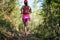 Trail runner running in forest trail