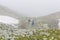 Trail runners in a mountain race and tourists hiking on Retezat mountain