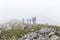 Trail runners in a mountain race and tourists hiking on Retezat mountain