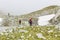 Trail runners in a mountain race and tourists hiking on Retezat mountain