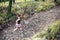 Trail running athletic woman in green forest, sports inspiration