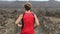 Trail running race - man runner running away in close up slow motion with woman runner in background. Cross country