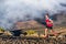 Trail running runner man on endurance run with backpack on volcano mountain. Ultra marathon race athlete on volcanic rocks path in