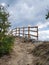 Trail with a wooden railing, footpath, country road, alley, lane in Bulgarian forest and the sky as background.